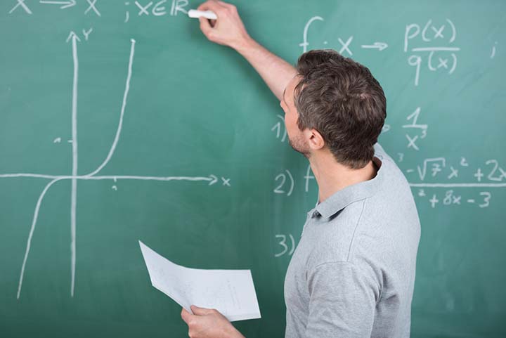 img-teacher writing on chalkboard